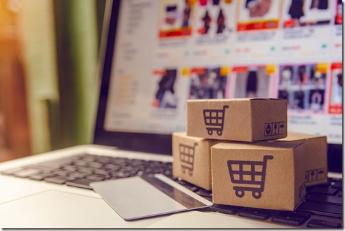 Shopping online concept - Shopping service on The online web. with payment by credit card and offers home delivery. parcel or Paper cartons with a shopping cart logo on a laptop keyboard